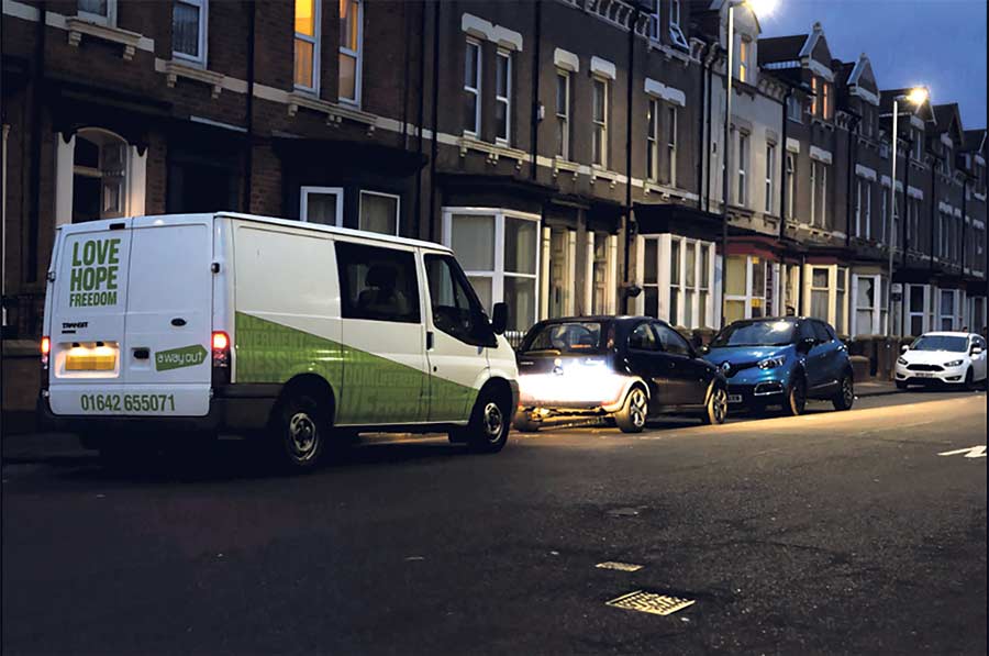White van on an ordinary suburban street at dusk