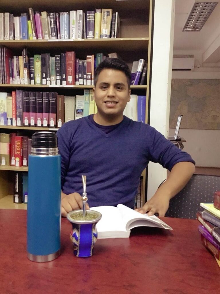 young Latino man in library