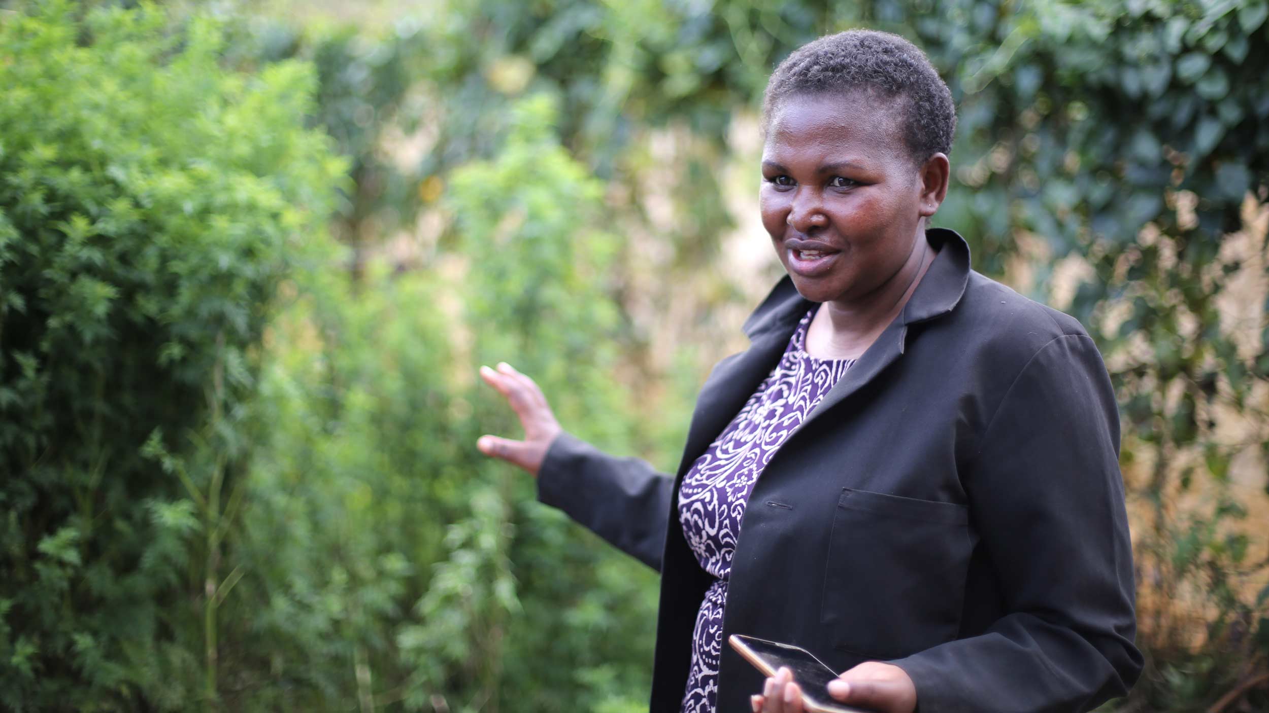 confident black woman explaining garden enterprise