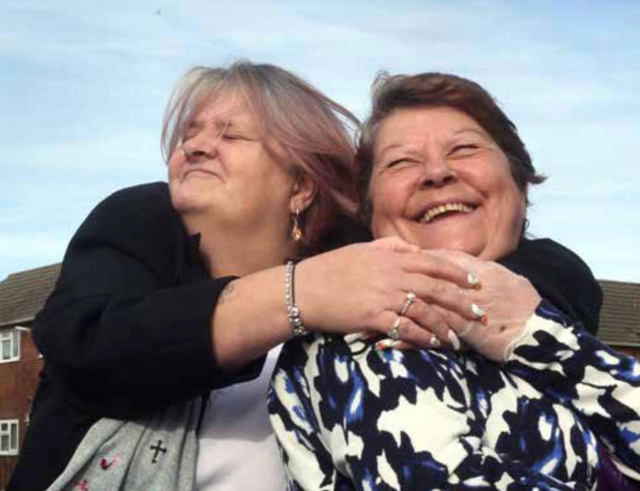 Two smiling women embracing