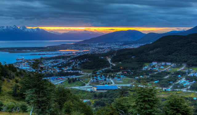 Sunset view of mountains, city and inlet
