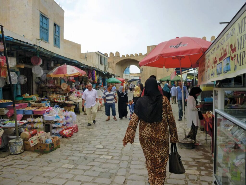 a woman walks through a North African market