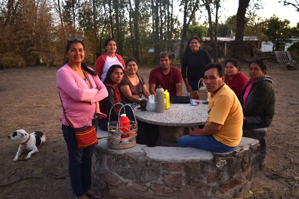 a group of delegates catching up around a table outdoors