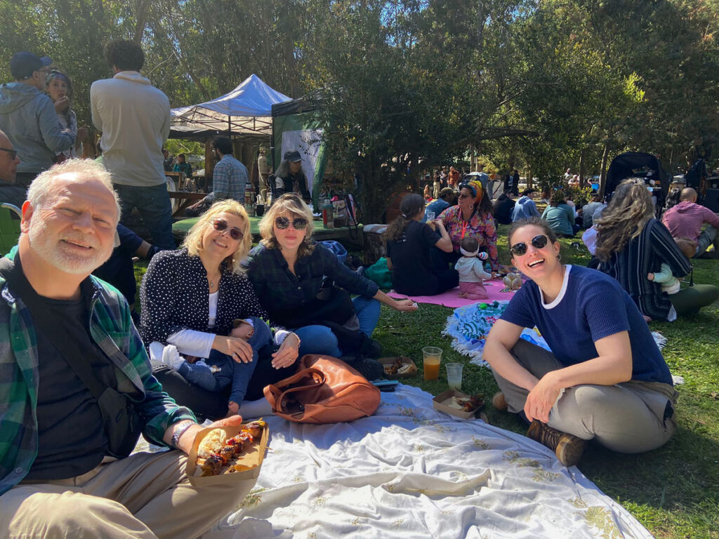 Daniel, Mechi and friends share a picnic in the park