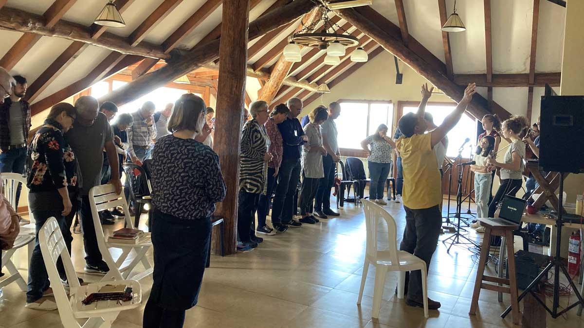 People in mission worshipping together indoors