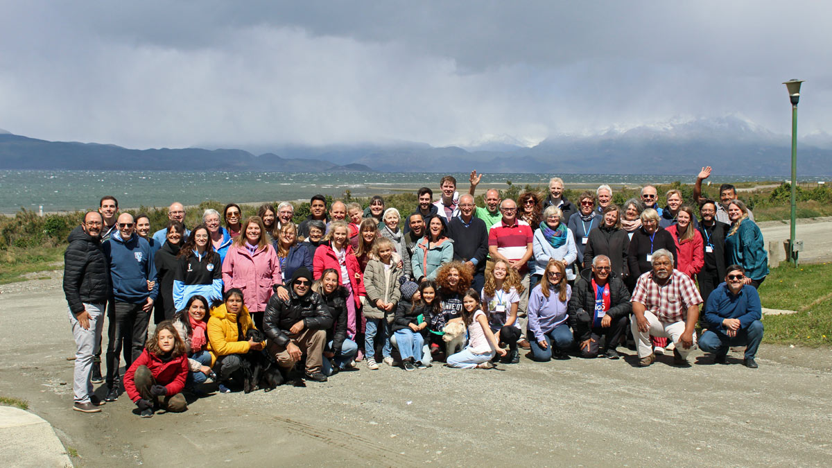 CMS people in mission gathered in Ushuiaia, with a backdrop of mountains and sea