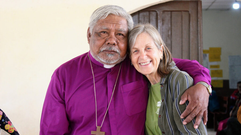 Indigenous bishop puts his arm round Catherine's shoulder