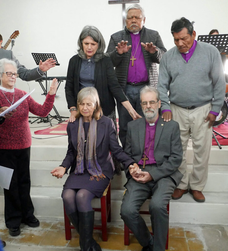 Bishops and others gather round to pray