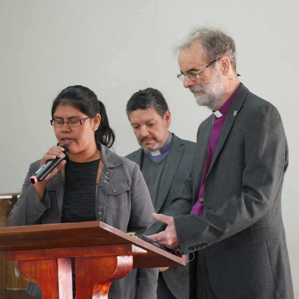 Young Wichi woman prays for Bishop Nick