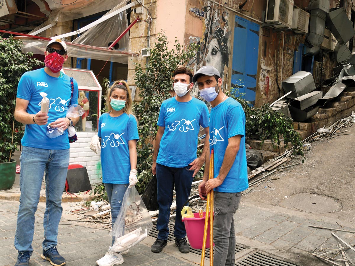 volunteers with cleanup gear in bright blue church t-shirts