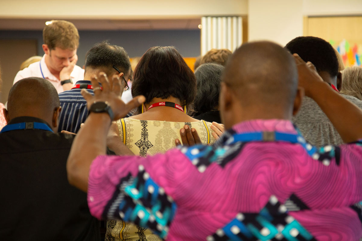 Africna leaders pray a blessing on Asian colleagues