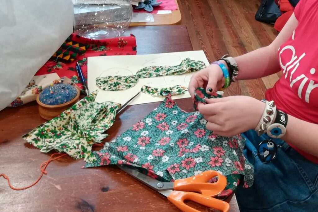 woman's hands working with colourful fabric