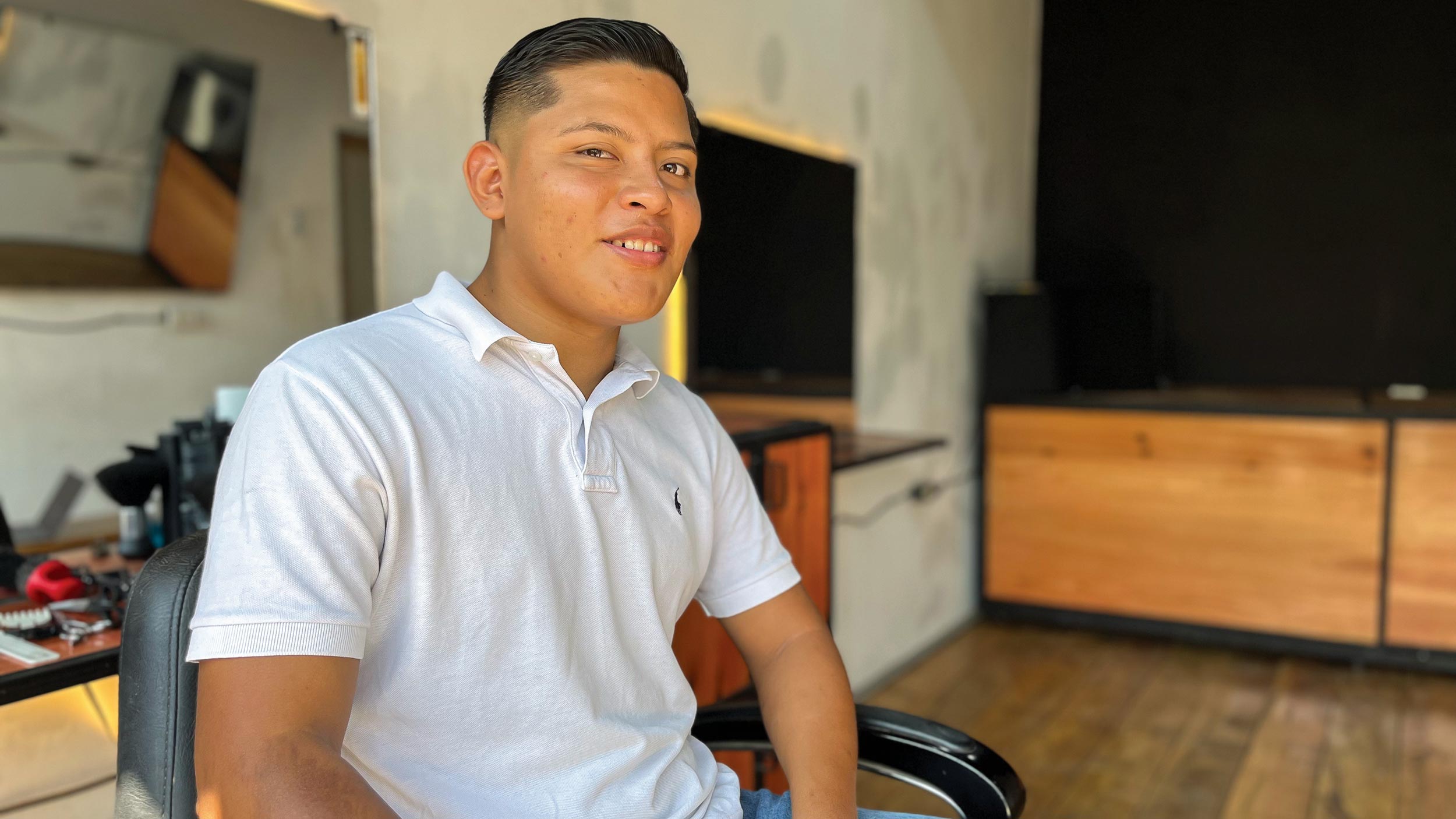 Owen smiles as he sits in his barber's chair