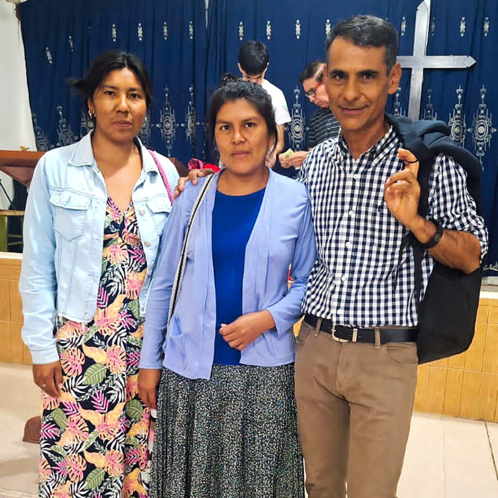 two smartly dressed indigenous women with male