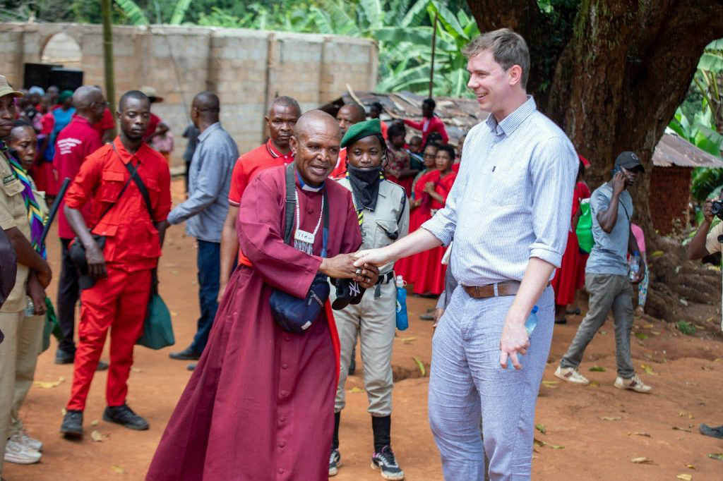 Andy is greeted by an animated Archbishop Maimbo