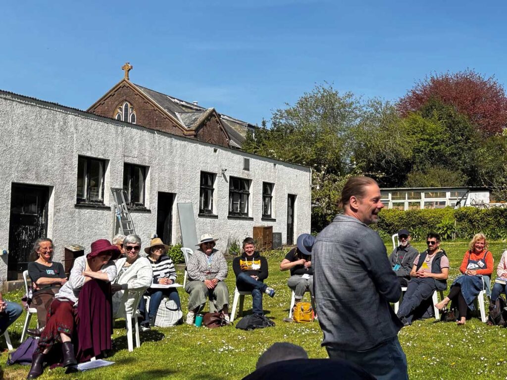 people sit round in sun-soaked garden