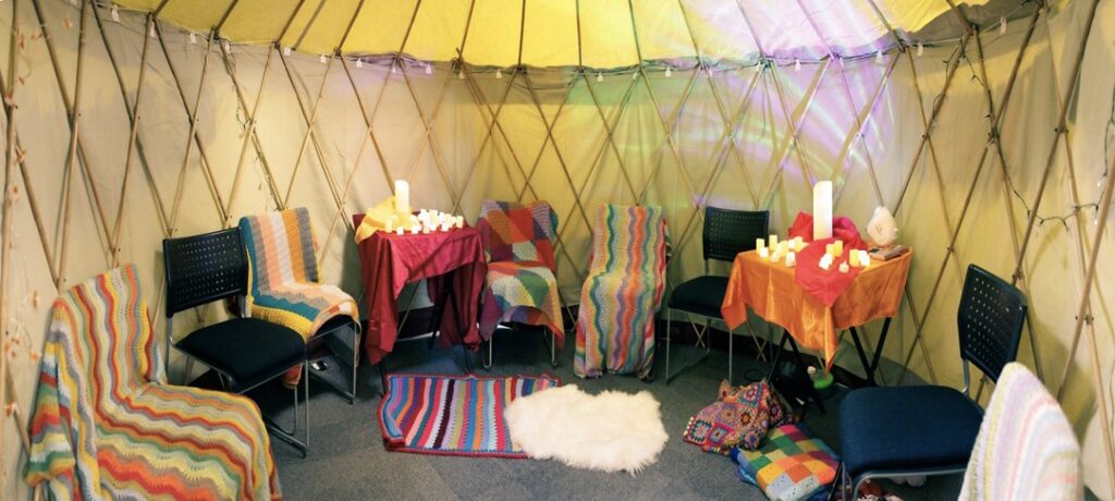 yurt interior with chairs, throws and candles