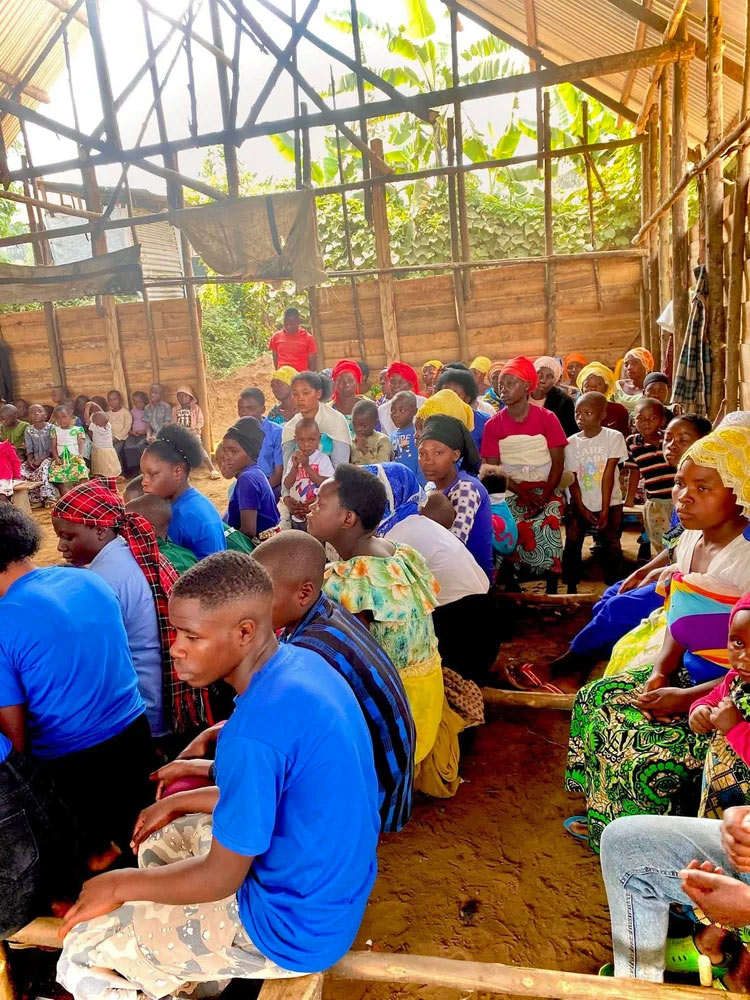 congregation packed into airy wooden church building